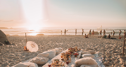 Private picnic on beach during sunset